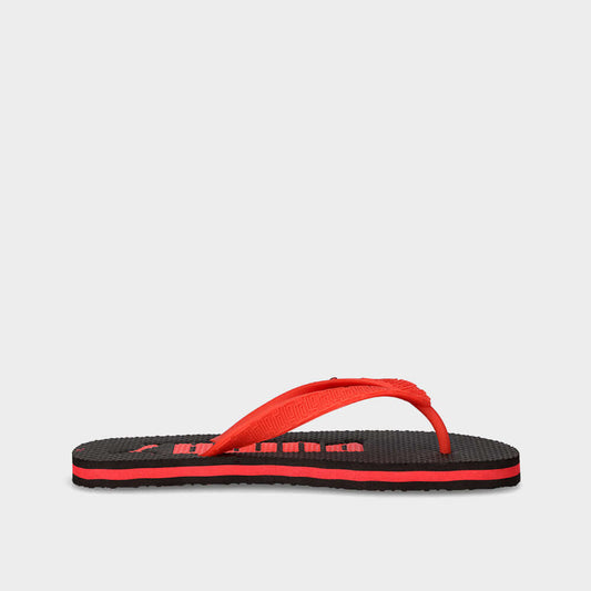 Puma Youth Essential Flip Ii Thong Sandals Black side view showcasing thin rubber strap and spiked grip outsole.