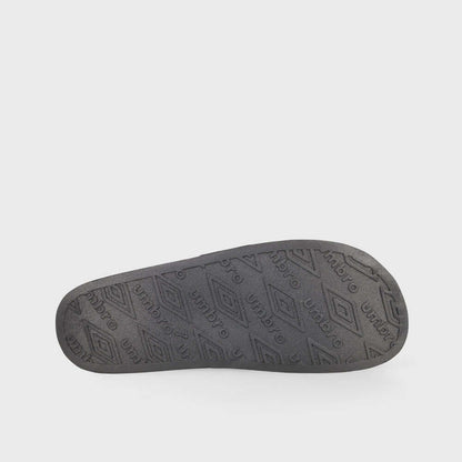 Bottom view of Umbro unisex sport slides in black, showcasing the textured outsole for grip and durability.