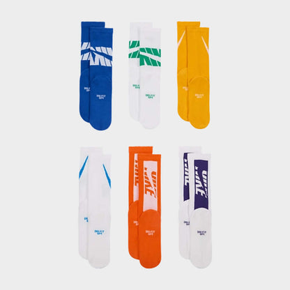 Nike unisex everyday cushion crew socks in blue, green, yellow, orange, and white, featuring Dri-FIT technology for comfort.